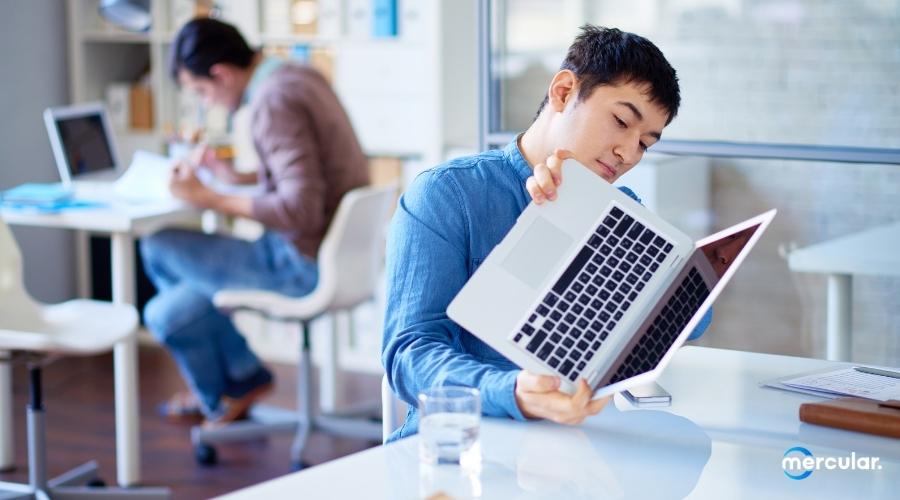 man flipping checking notebook computer fixing