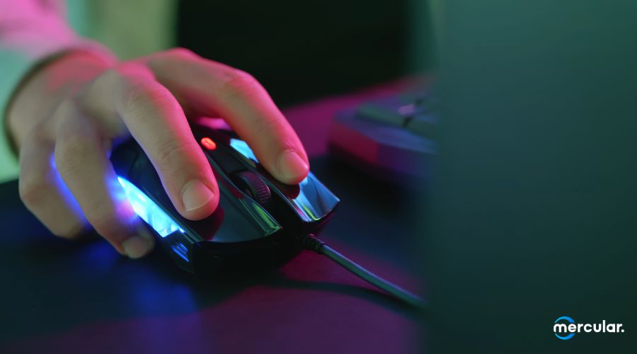 hand gripping mouse rgb lighting dark