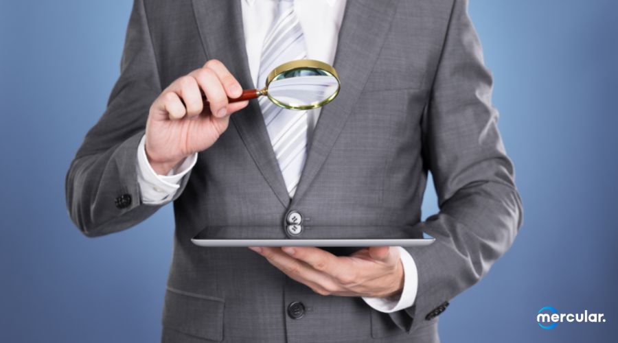 man holding magnifier on tablet